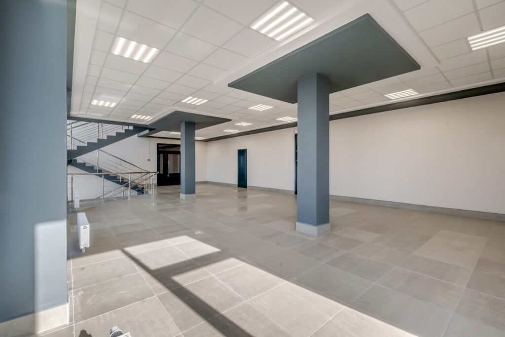 empty modern hall room with columns, doors and panoramic windows.