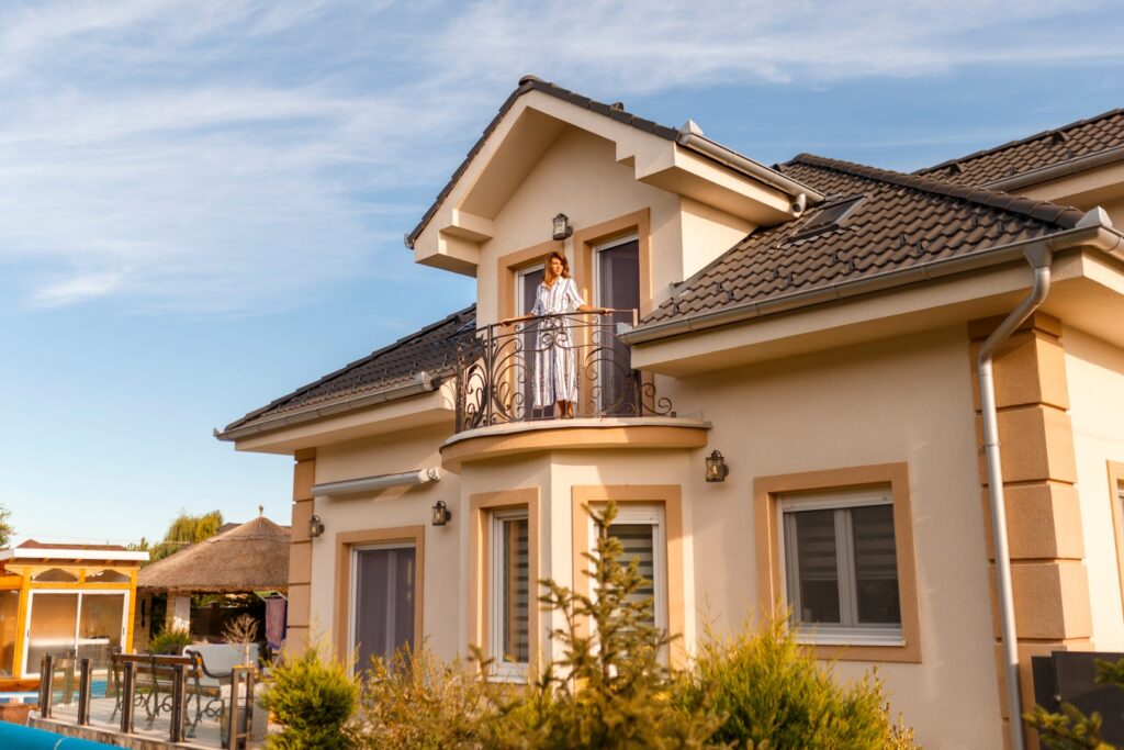 Woman standing on her new house balcony