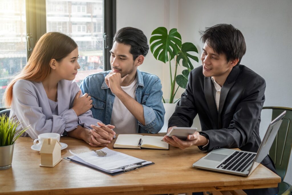 Residential real estate agent discussing home options with first-time buyers.
